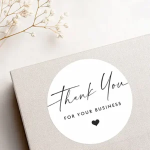 Thank you for business script heart white classic round sticker Business sticker featuring the words "Thank You" in an elegant black handwritten script font, followed by "FOR YOUR BUSINESS" in a clean, capitalized sans-serif font stack. A small solid black heart icon is centered directly beneath the text.