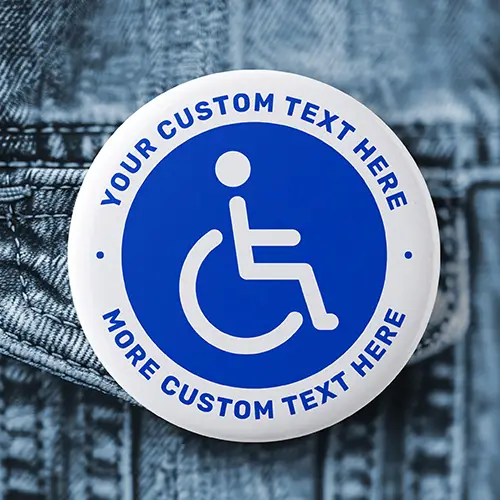 Round pin-back badge featuring a white wheelchair accessibility icon on a blue circular background, encircled by a white rim with custom arched blue text.