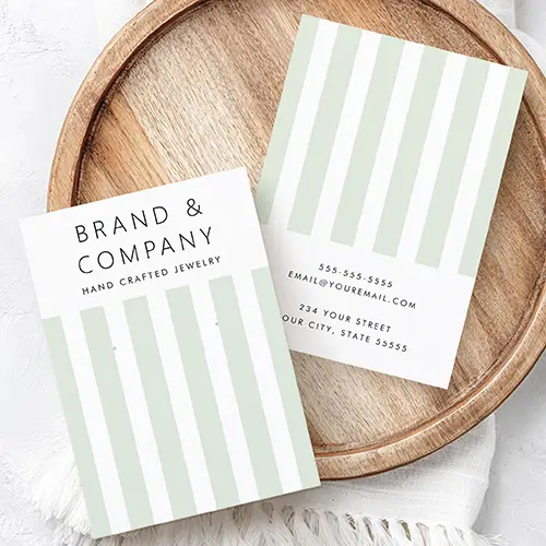 Double-sided earring display card displaying sage green vertical stripes, clean brand header typography, and rear contact text fields.