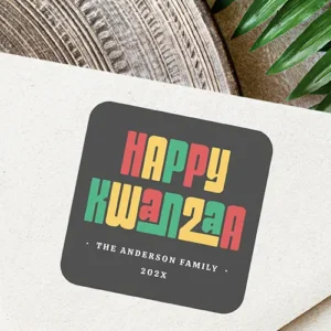 Happy Kwanzaa red green yellow text Square Sticker Square self-adhesive label featuring red, green, and gold stacked Happy Kwanzaa typography on dark grey, with customizable white text at the bottom.