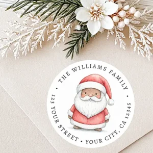 Circular white return address label sticker featuring a cute watercolor story-book style Black Santa illustration in the center with curved black serif family name and address typography along the outer edge.