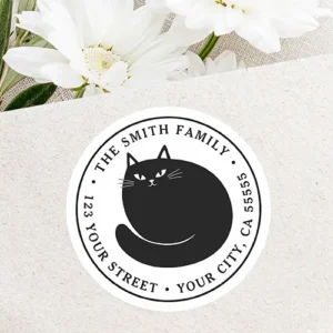 Cute black cat kitten return address classic round sticker Round white self-adhesive return address label featuring a central illustrated black cat curled up with circular black serif text along the inner border.