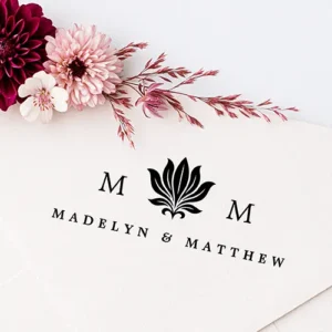 Elegant lotus flower monogram initials & names rubber stamp Rubber stamp design featuring a central stylized lotus flower leaf motif flanked by two serif initial letters and custom text centered below