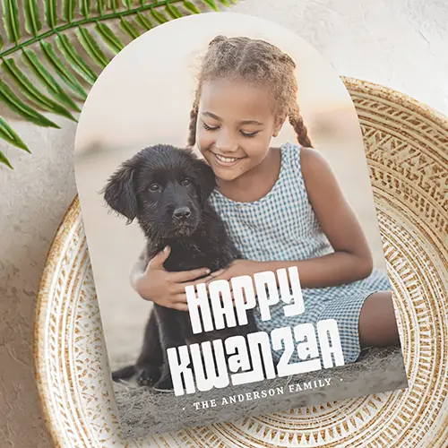 Arched photo card featuring a full-bleed custom photo, white Happy Kwanzaa block typography, and a dark charcoal back with custom text space.