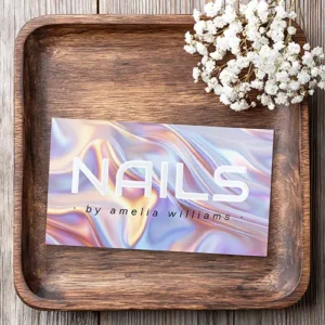 Modern nails nail technician stylist foil business cards Double-sided beauty business card with a printed iridescent liquid silk background, raised gloss text reading NAILS on the front, and contact details on a white diagonal block on the back.