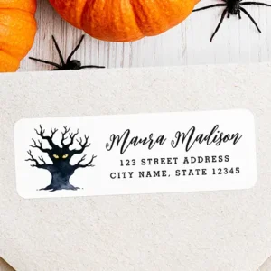 Spooky gnarly Halloween tree return address Label Halloween return address sticker displaying a gnarled black tree silhouette beside template text for name and address in script and serif fonts.