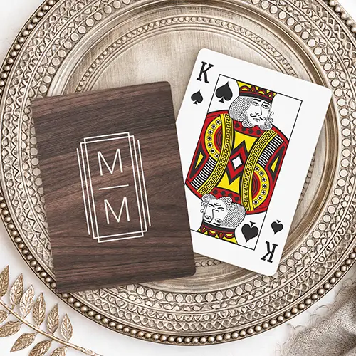 Playing cards featuring a horizontal dark espresso wood grain background with a centered white triple rectangular frame containing two stacked custom letters separated by a line.