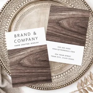A vertical earring display card featuring a white header block with black text above a printed dark walnut wood grain background with two white guide dots.